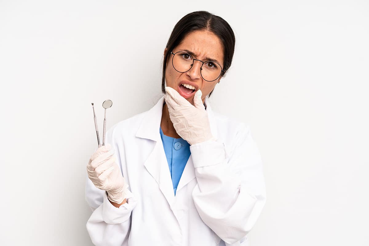A photo of a dentist holding dental tools