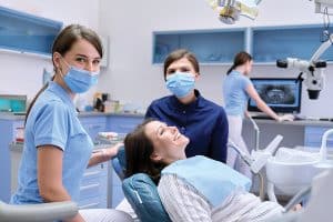 Dentists with a smiling patient
